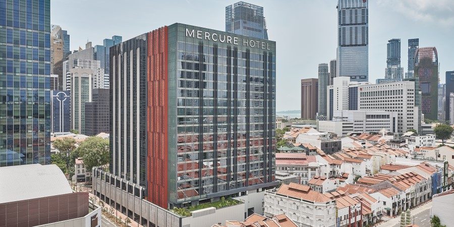 is centrally located, surrounded by several tall skyscrapers in an urban setting.